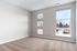 Bright and spacious room with large windows offering serene views of trees and snow.