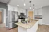 Modern kitchen with granite countertops, sleek stainless steel appliances, and elegant pendant lighting.