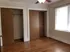 Bright bedroom with elegant hardwood floors, ample natural light, and spacious closet space, perfect for a cozy retreat.