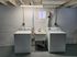 Bright and functional laundry room featuring modern washer and dryer units with a convenient utility sink.