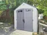Charming garden shed nestled among lush greenery, offering a perfect outdoor storage solution.