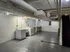 Spacious, well-lit basement with laundry facilities, featuring a washer and dryer, ample storage, and modern utility setup.