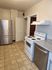 Inviting kitchen featuring modern stainless steel appliances, sleek countertops, and bright tile flooring.