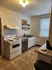 Charming kitchen with modern appliances, ample counter space, and elegant lighting.