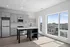 Bright modern kitchen with sleek gray cabinets, large windows offering panoramic city views, and stylish countertops.
