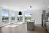 Bright, modern kitchen with sleek appliances and expansive windows offering stunning views.