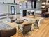 Elegant open-concept living space featuring modern furnishings, stylish seating, and a cozy central fireplace.