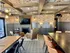 Chic living space featuring elegant exposed beams, ambient lighting, and plush seating, perfect for cozy gatherings.