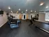 Modern fitness center with state-of-the-art cardio machines, free weights, and mirrored walls for an enhanced workout experience.