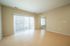 Bright and airy living room with large sliding glass doors, natural light, and elegant hardwood floors.