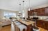 Modern open-concept living area with elegant granite countertops, stylish kitchen, and cozy seating, boasting stunning city views through large windows.