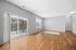 Elegant, light-filled living room with hardwood floors and a private balcony access, ideal for relaxing.