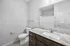 Modern bathroom with granite countertop, sleek fixtures, and elegant neutral tones for a sophisticated feel.