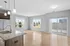 Bright and modern open-concept living area with hardwood floors, granite kitchen island, and large windows offering ample natural light.