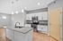 Modern kitchen with sleek countertops, stainless steel appliances, and elegant pendant lighting, perfect for culinary enthusiasts.