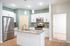 Contemporary kitchen with sleek stainless steel appliances, elegant granite countertops, white cabinets, and inviting hardwood floors.