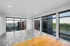 Bright modern living space with large floor-to-ceiling windows offering stunning views and abundant natural light.