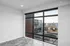 Modern apartment interior showcasing large windows with stunning urban views and ample natural light.