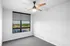 Bright modern room with large window view and sleek ceiling fan, perfect for a cozy bedroom or office space.