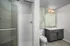 Modern bathroom with a sleek glass-enclosed shower and stylish vanity mirror.