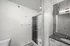 Sleek modern bathroom with a glass-enclosed shower, elegant vanity, and stylish accents.
