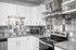 Sleek modern kitchen with stylish gray tile backsplash, stainless steel appliances, and crisp white cabinets for a contemporary look.
