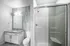 Sleek and modern bathroom featuring a stylish vanity, spacious shower, and elegant lighting.