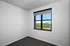 Bright and inviting room with a large window showcasing a scenic green view, promising natural light and tranquility.