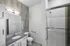 Modern bathroom featuring sleek countertops, contemporary lighting, and a glass-enclosed shower for a luxurious touch.