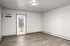 Stylish and bright room with modern flooring and a sleek glass door leading to a balcony, perfect for enjoying natural light.