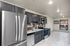 Modern kitchen with stainless steel appliances, sleek cabinetry, and spacious layout, perfect for culinary enthusiasts.