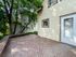 Charming outdoor deck with natural wood finish and lush green surroundings, perfect for relaxation and entertaining.