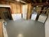 Spacious laundry room with washer and dryer, fresh painted floor, and ample storage space.