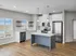 Modern kitchen with stainless steel appliances, sleek white cabinetry, and elegant pendant lighting over a stylish island.