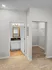 Chic modern interior featuring a bright walk-in closet and elegant bathroom with stylish lighting fixtures.