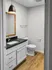 Modern bathroom featuring sleek black countertop, stylish lighting, and elegant wood flooring.