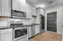 Modern kitchen with sleek stainless steel appliances, elegant white cabinetry, and stylish subway tile backsplash.