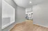 Bright, modern apartment interior featuring sleek white cabinets and stainless steel appliances in an inviting open-concept kitchen.