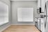 Bright and modern kitchen with sleek stainless steel appliances, white cabinets, and large windows allowing ample natural light.