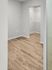 Bright and spacious walk-in closet with elegant wooden flooring and ample shelving.