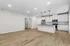 Modern open-concept kitchen with elegant white cabinetry, stainless steel appliances, and ambient pendant lighting.