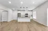 Modern kitchen with sleek cabinetry, a central island, and stylish pendant lighting in an open-concept floor plan.