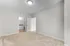 Spacious bedroom with soft carpet flooring and a view into an en-suite bathroom featuring modern finishes.