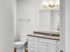Modern bathroom with sleek fixtures, a large mirror, and elegant lighting, creating a bright and inviting space.