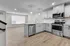 Contemporary kitchen with stainless steel appliances, sleek cabinetry, and open floor plan with ample natural light.
