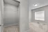 Bright, spacious room with plush carpet, large window, and ample walk-in closet space.