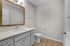 Modern bathroom with elegant vanity, large framed mirror, and sleek fixtures, perfect for a contemporary home.