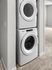 Modern stacked washer and dryer set in a sleek utility nook, offering convenient laundry solutions.