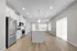 Spacious modern kitchen with sleek stainless steel appliances, elegant cabinetry, and a large central island in a bright open-concept layout.