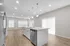 Modern kitchen with sleek white cabinetry, spacious island, and bright lighting, perfect for gourmet cooking.